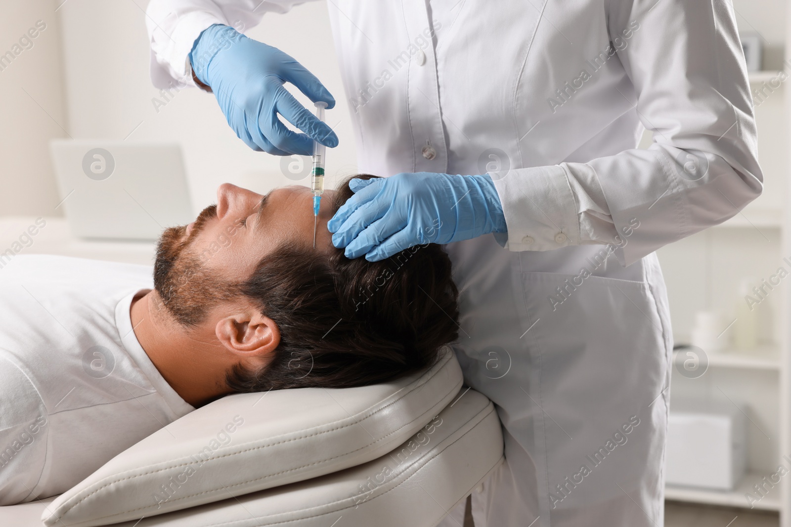 Photo of Trichologist giving injection to patient in clinic, closeup