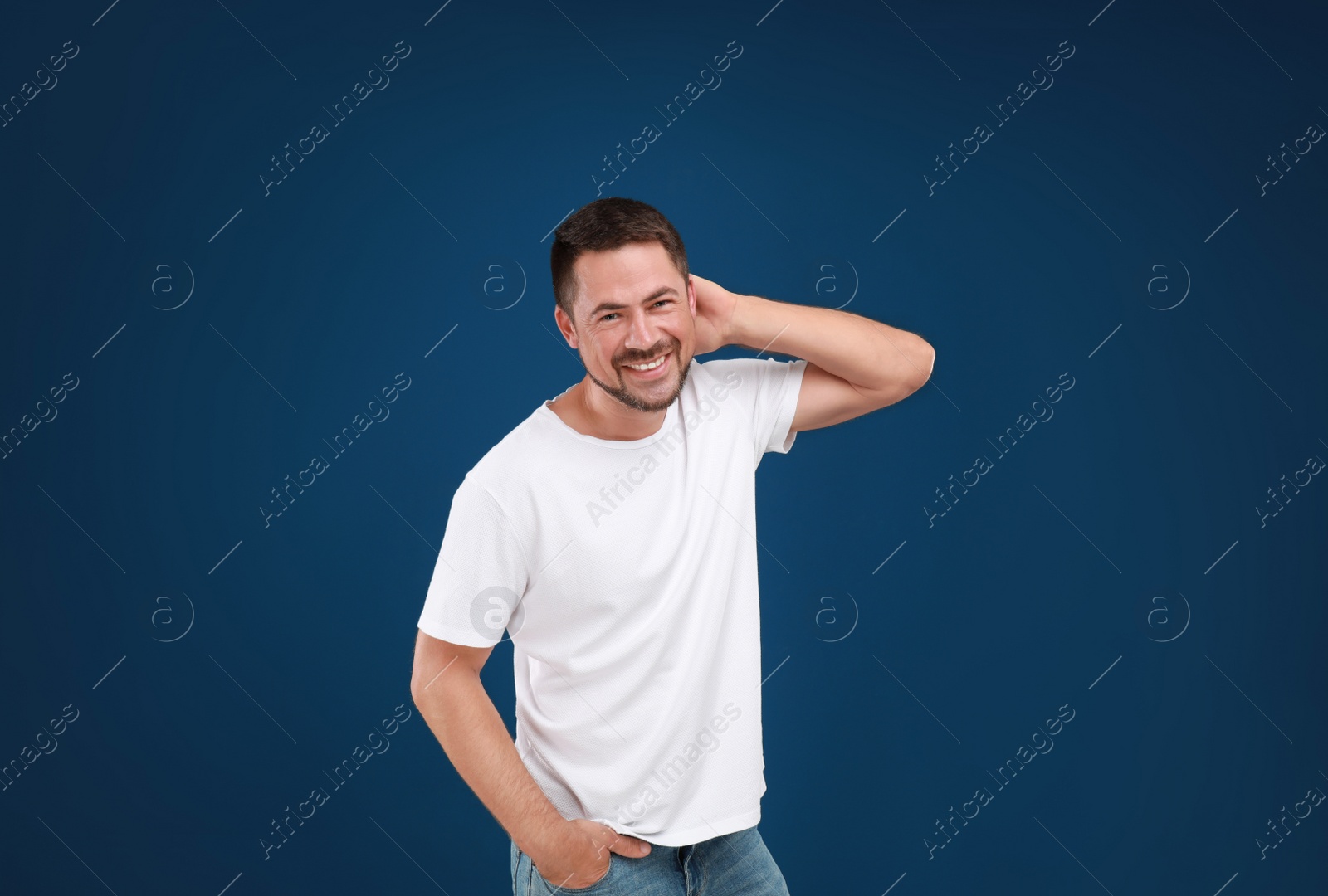 Photo of Portrait of handsome man on blue background