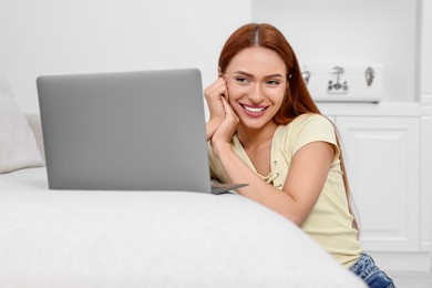 Photo of Woman having video chat via laptop at home