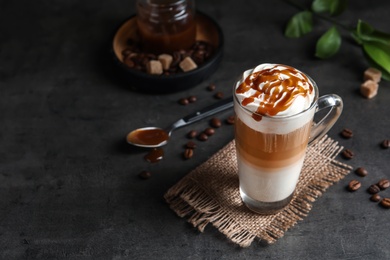 Photo of Glass cup with delicious caramel frappe on table