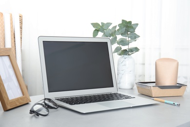 Photo of Cozy blogger workplace with laptop at home