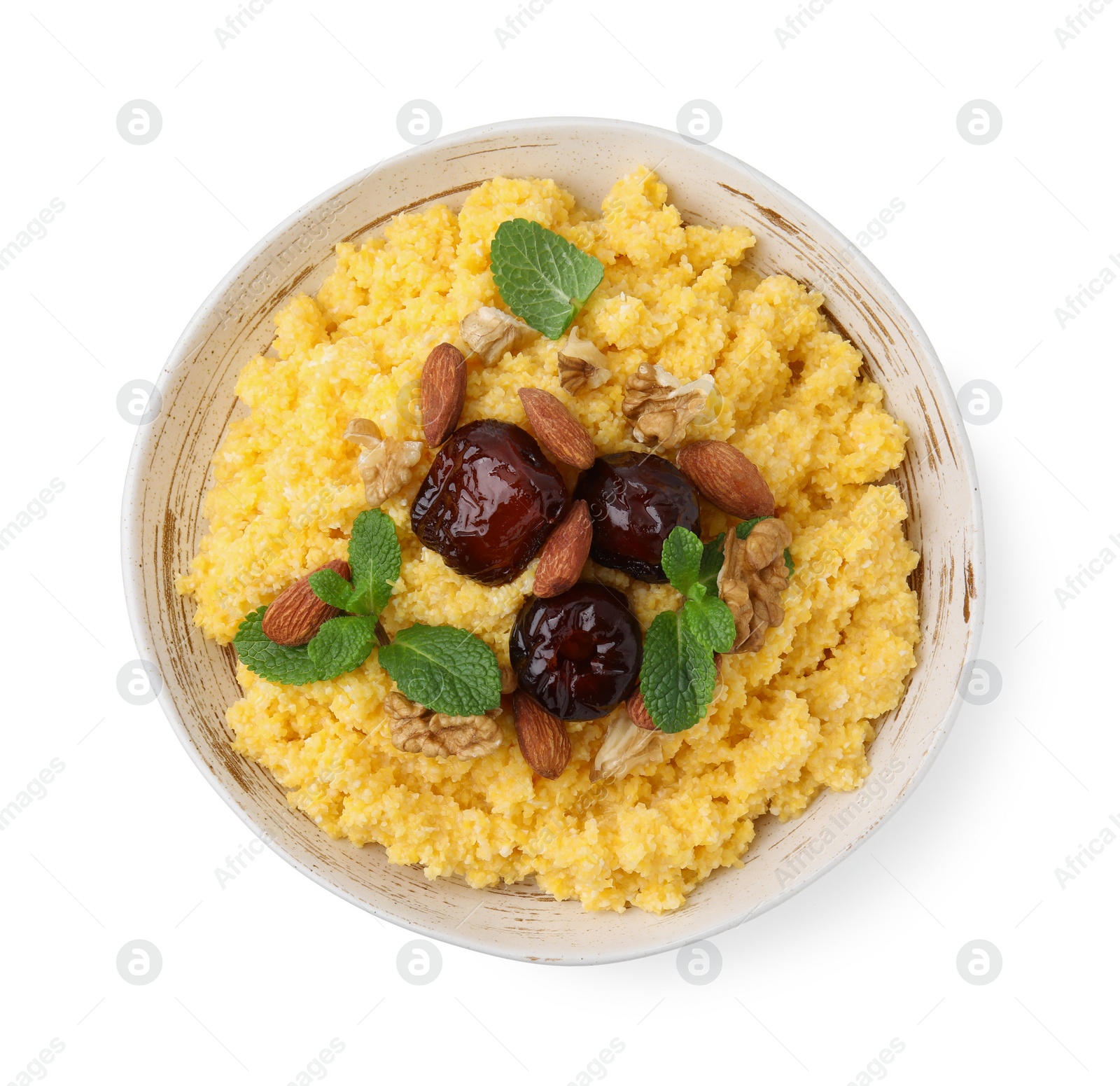 Photo of Tasty cornmeal with dates, nuts and mint in bowl isolated on white, top view