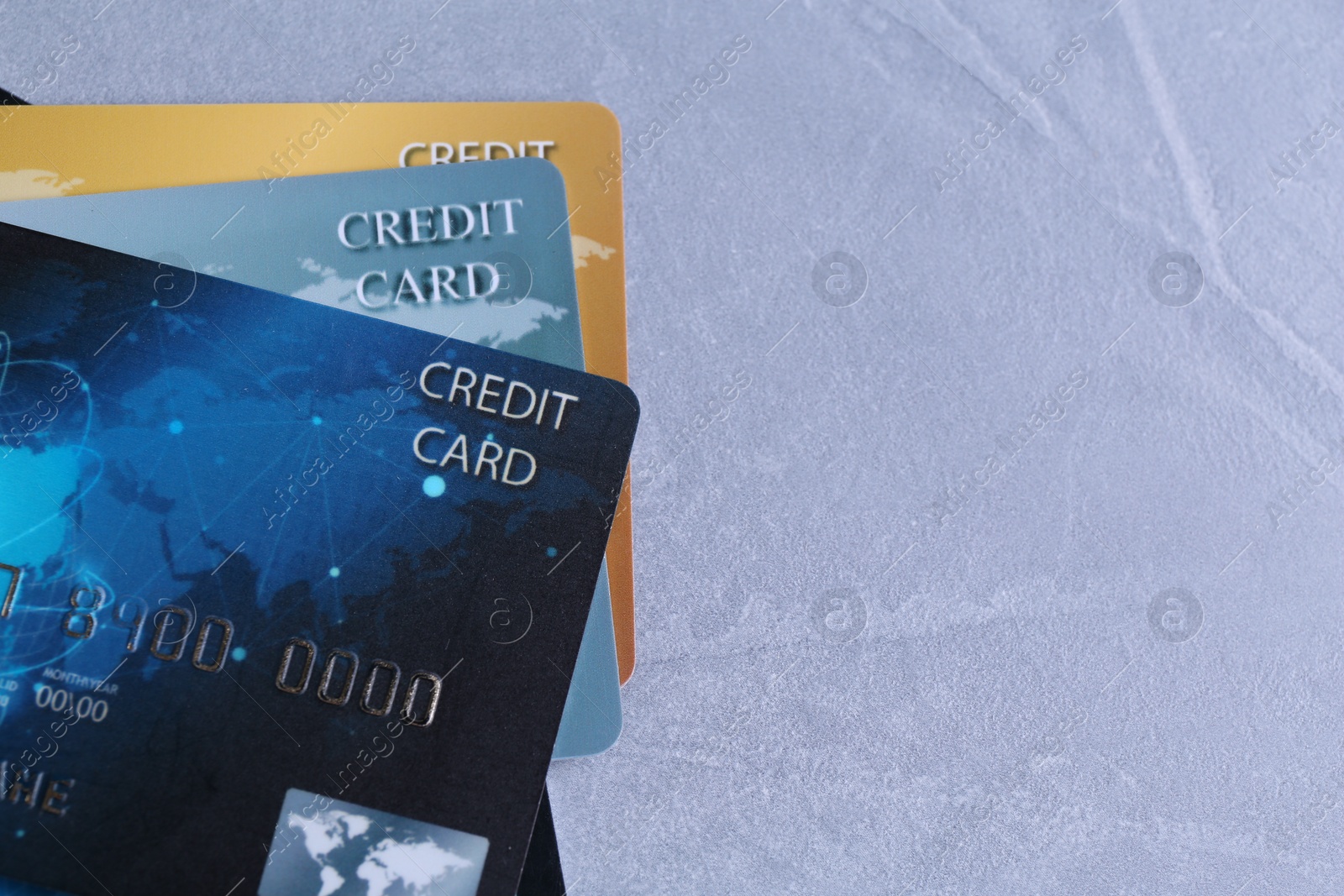 Photo of Many credit cards on grey textured table, flat lay. Space for text