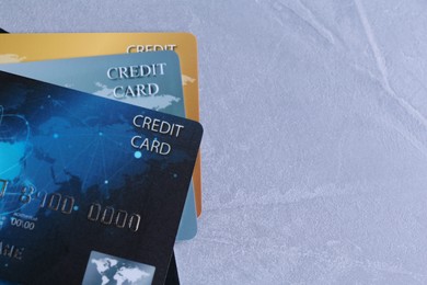 Many credit cards on grey textured table, flat lay. Space for text