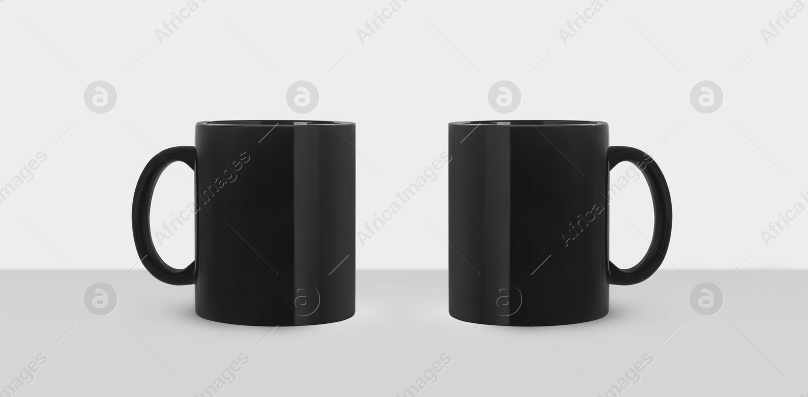 Image of Black ceramic mugs on white background, banner design. Mockup for design