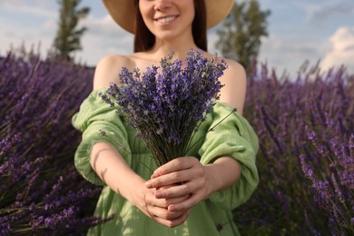 Photo of Smiling woman with bouquet in lavender field, closeup
