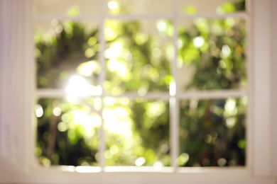 Photo of Blurred view through window on garden in morning