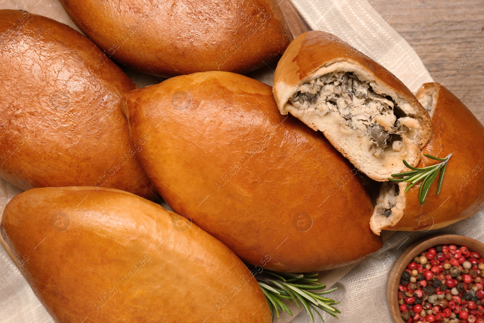 Photo of Many delicious baked patties on table, flat lay