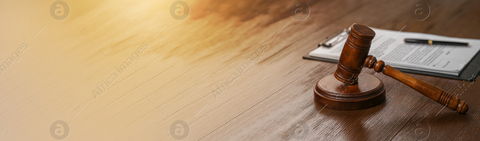 Image of Law concept. Gavel and documents on wooden table. Banner design with space for text