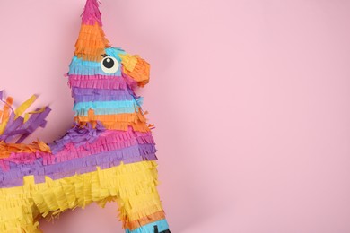 Bright donkey pinata on pink background, top view. Space for text