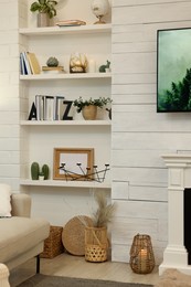 Photo of Shelves with different decor in room. Interior design