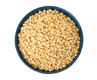 Bowl with pine nuts on white background, top view