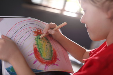 Little boy drawing at home, closeup. Creative hobby