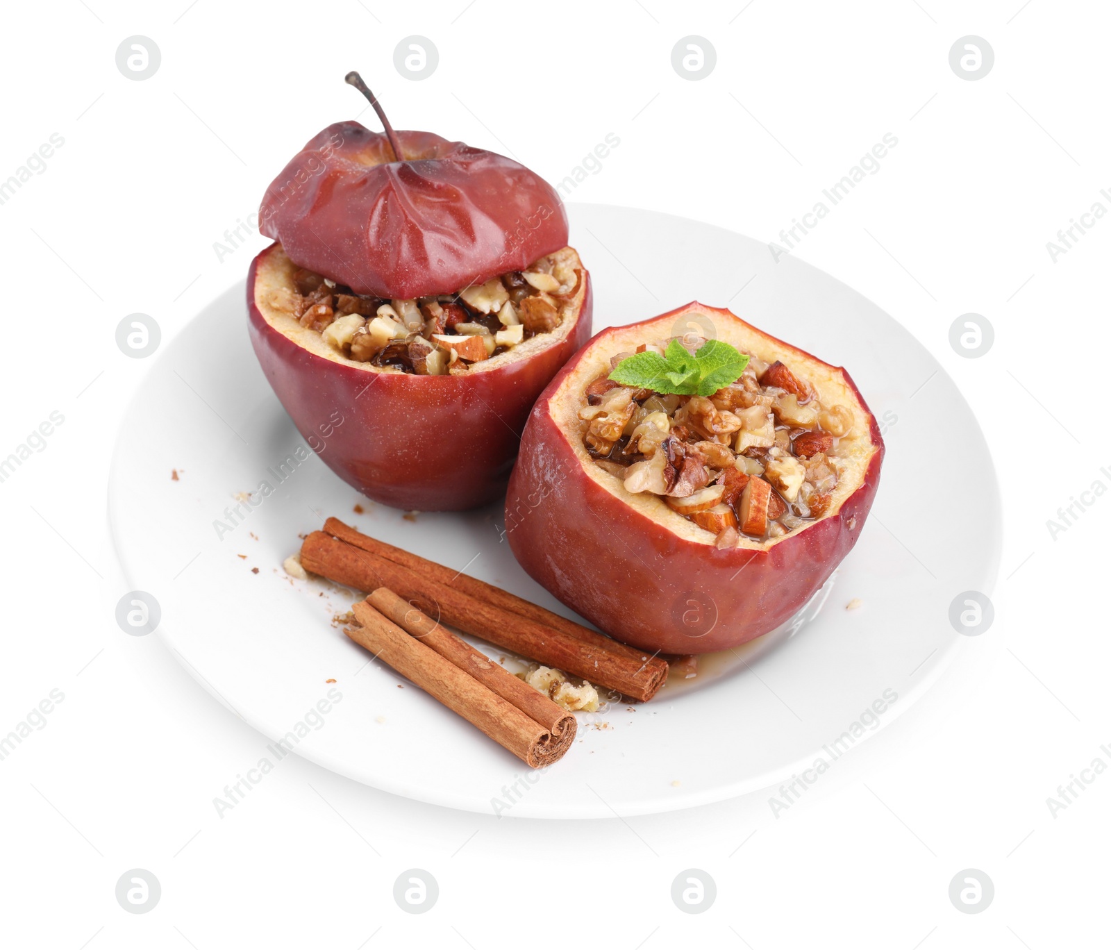 Photo of Tasty baked apples with nuts, honey, cinnamon sticks