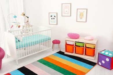 Photo of Colorful baby room interior with comfortable crib