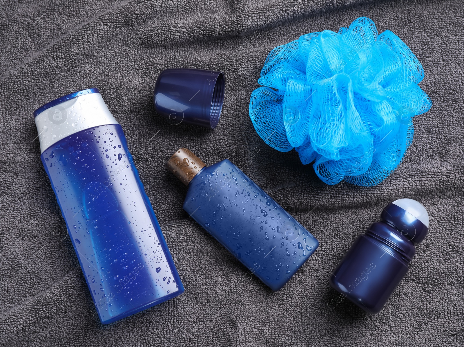 Photo of Flat lay composition with men's cosmetics on grey towel