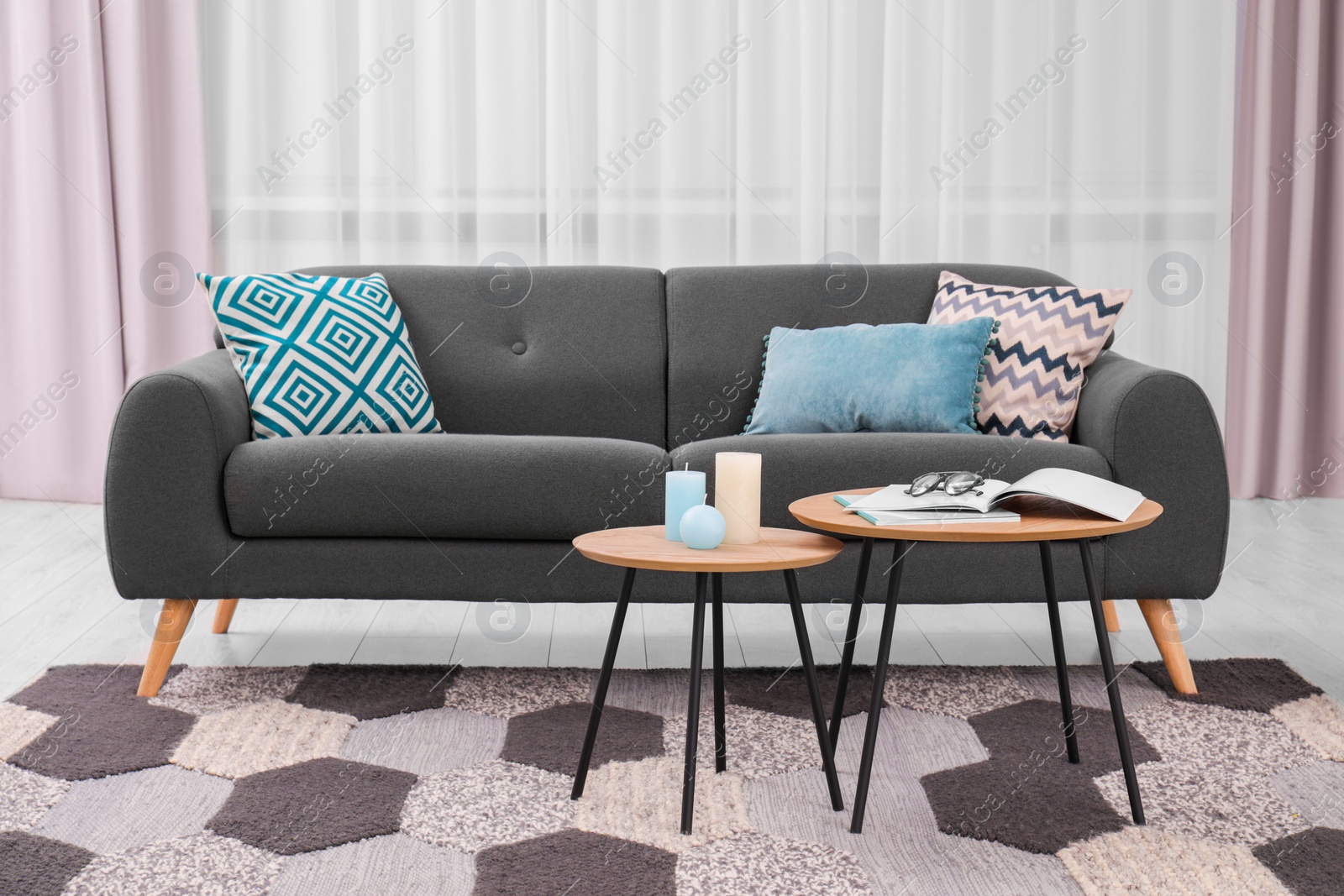 Photo of Comfortable sofa, floor lamp and coffee table in stylish room. Interior design