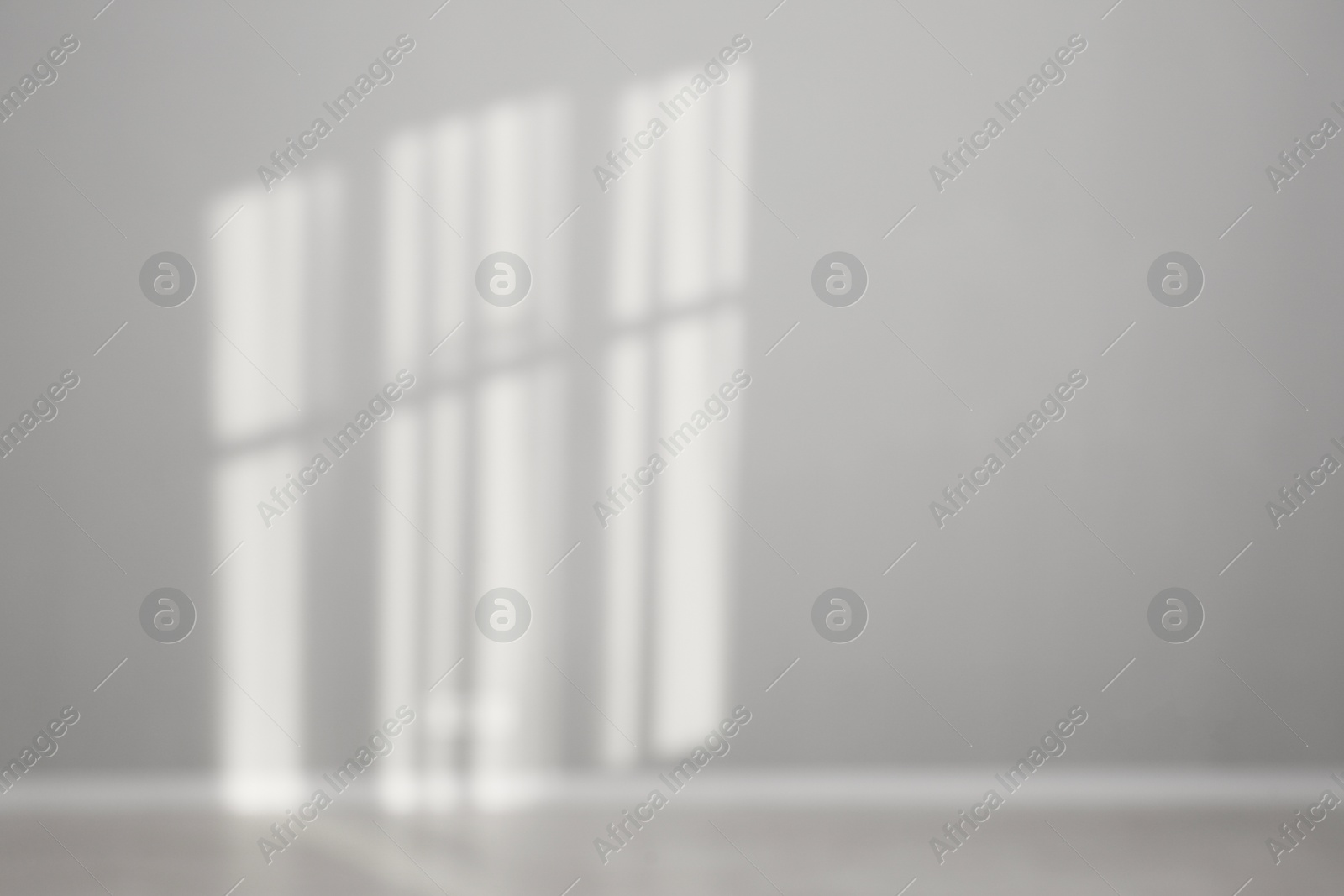 Photo of Light and shadows from window on wall indoors