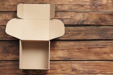 Photo of Cardboard box on wooden background