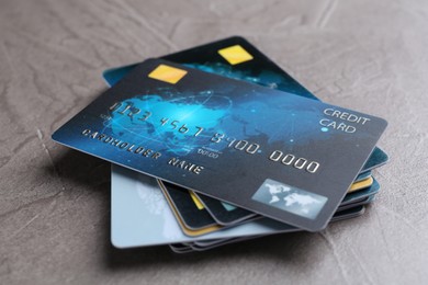 Photo of Credit cards on grey textured table, closeup