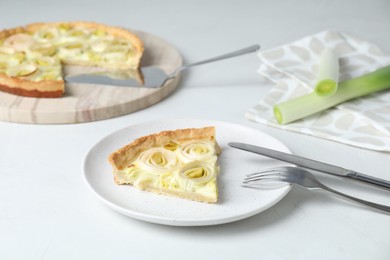 Photo of Piece of tasty leek pie served on white table