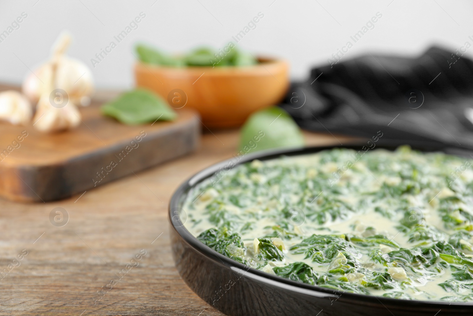 Photo of Tasty spinach dip on wooden table, closeup