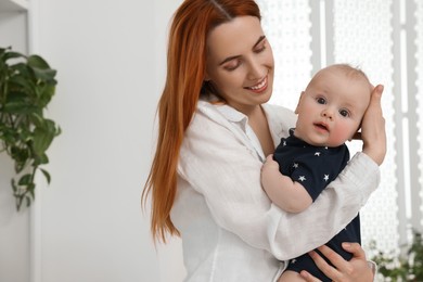Photo of Mother with her cute baby at home, space for text