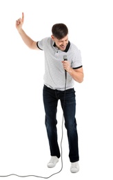 Handsome man in casual clothes singing with microphone on white background