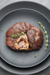 Delicious roasted beef meat with thyme on table, top view