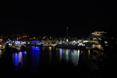 Photo of SPLIT, CROATIA - OCTOBER 08, 2023: Beautiful view of illuminated city with port and buildings at night