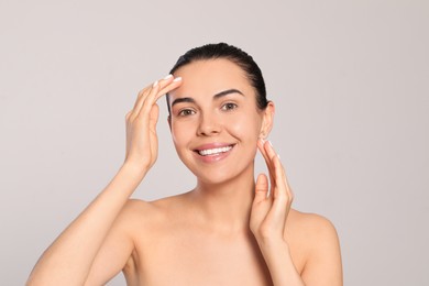 Photo of Beautiful young woman with perfect skin on light grey background