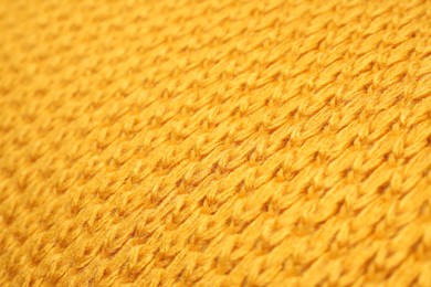 Texture of yellow knitted blanket as background, closeup