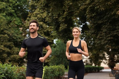 Healthy lifestyle. Happy couple running in park