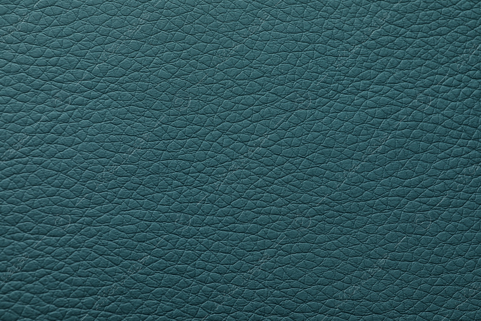 Photo of Texture of dark green leather as background, closeup
