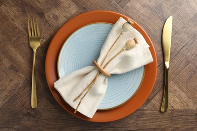 Photo of Stylish setting with cutlery and plates on wooden table, flat lay