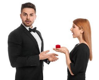Young woman with engagement ring making marriage proposal to her boyfriend on white background