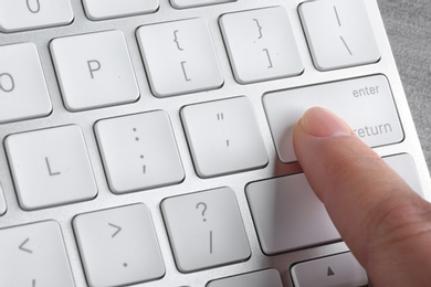 Photo of Woman pressing button on computer keyboard, closeup