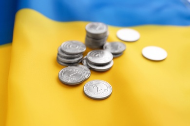 Photo of Ukrainian money on national flag, closeup view