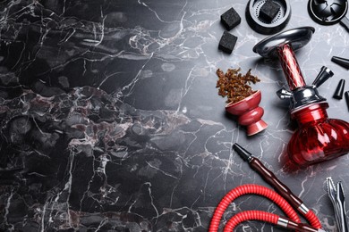 Flat lay composition with parts of hookah on black marble table, space for text