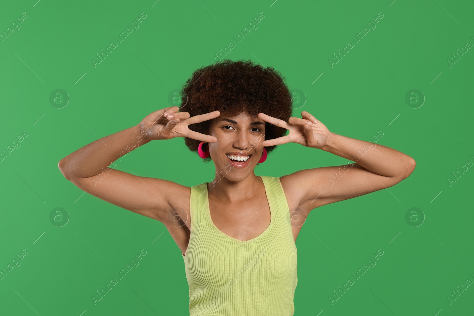 Photo of Portrait of happy young woman on green background