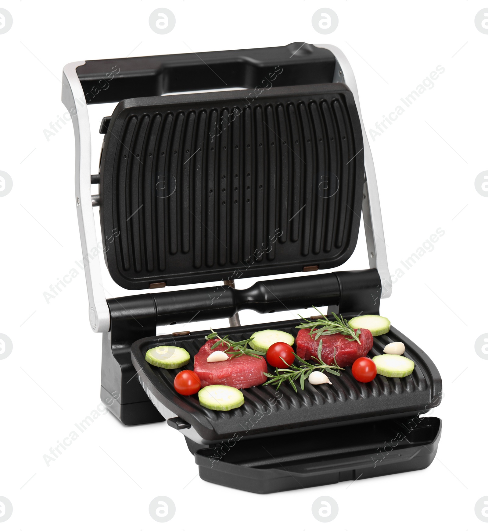 Photo of Electric grill with raw meat, rosemary and vegetables isolated on white