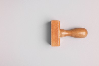 Photo of One wooden stamp tool on light grey background, top view. Space for text