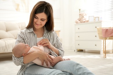 Mother holding her sleeping baby at home