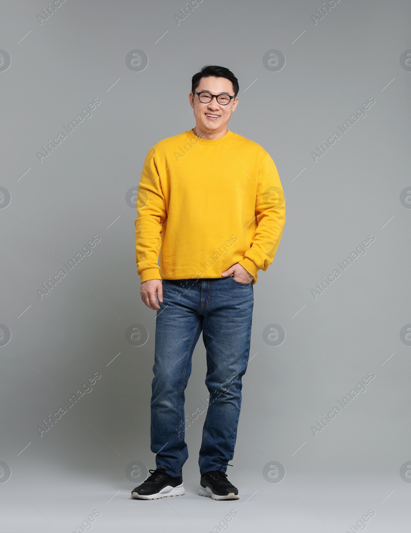 Photo of Full length portrait of happy man on grey background