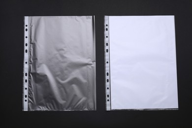 Photo of Punched pockets on black background, flat lay. Space for text