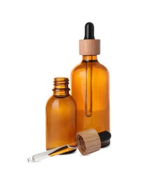 Photo of Bottles of essential oil and dropper on white background