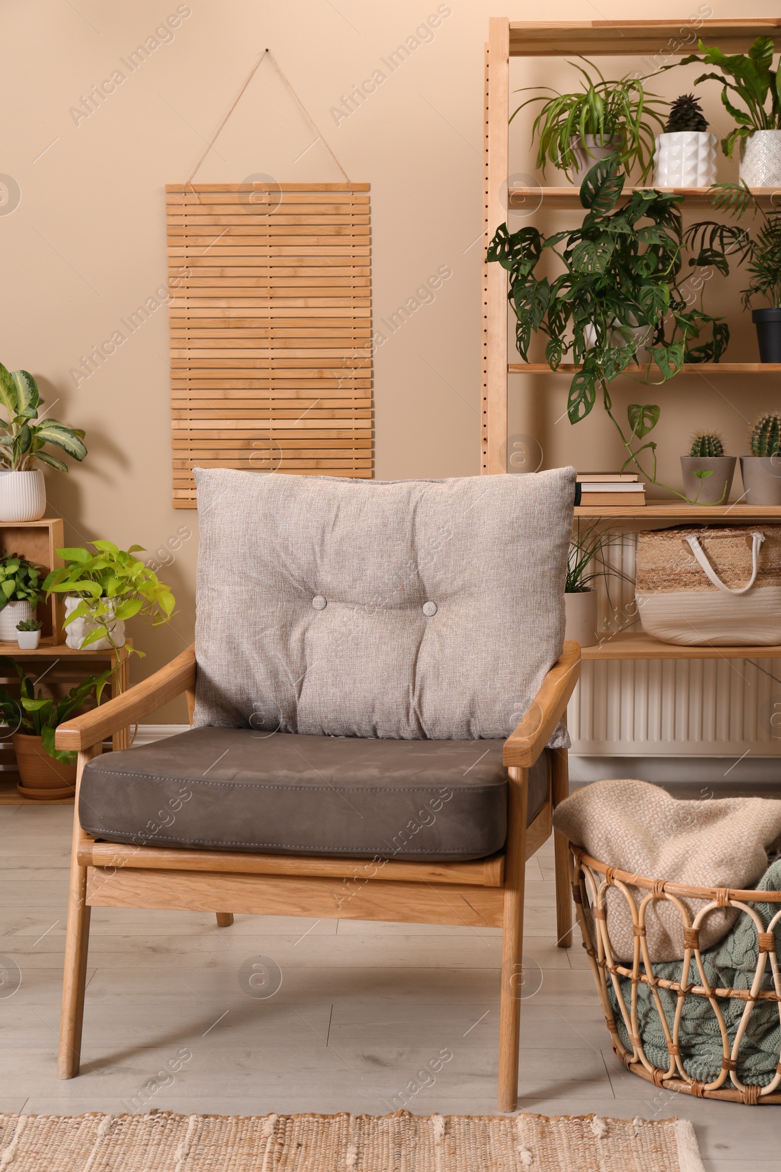 Photo of Lounge area interior with comfortable armchair and beautiful houseplants