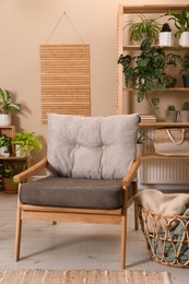 Photo of Lounge area interior with comfortable armchair and beautiful houseplants