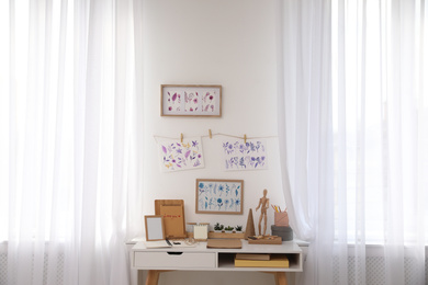 Photo of Stylish room interior with creative workplace near white wall