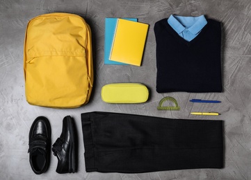 Flat lay composition with school uniform on grey background